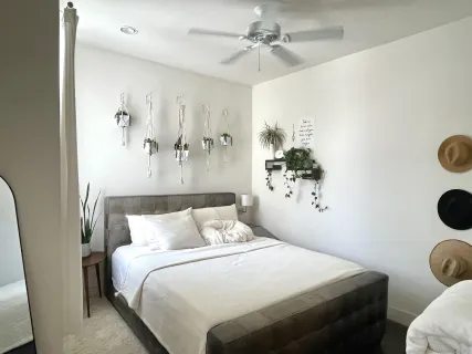 a bedroom with a bed and a chandelier