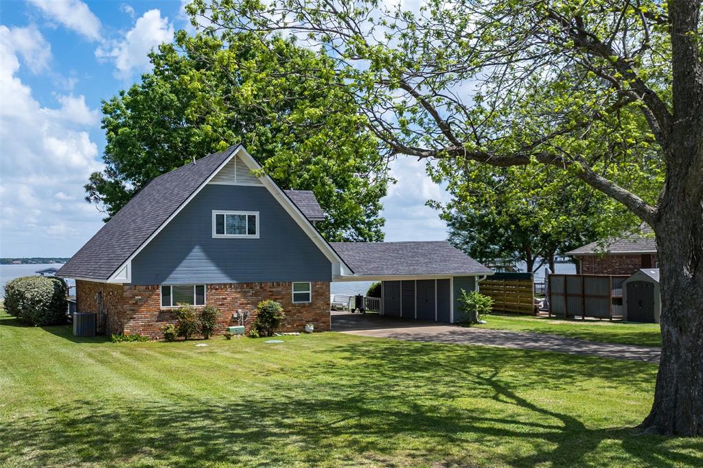 238 Matador Ranch Road Trinidad, TX 75163 - Photo 1 of 37 a front view of a house with a garden