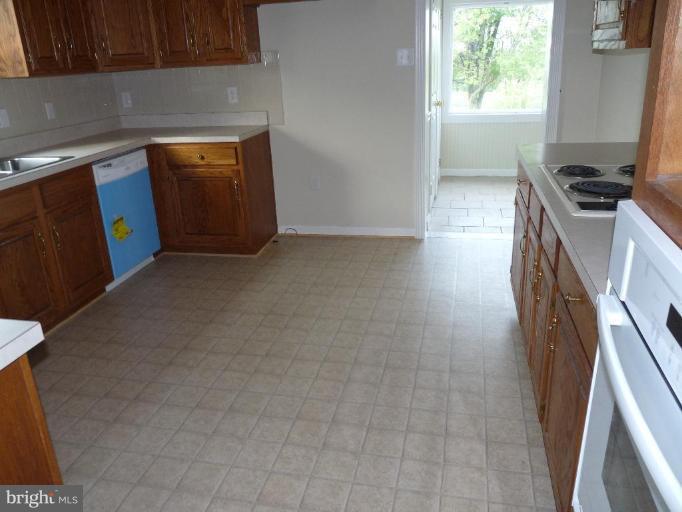 10127 Old Liberty Road Frederick, MD 21701 - Photo 2 of 8 a kitchen with a sink a stove and a refrigerator