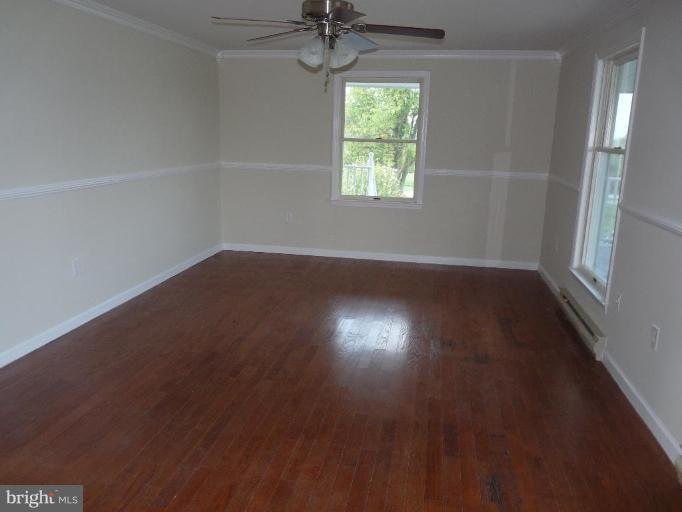 10127 Old Liberty Road Frederick, MD 21701 - Photo 3 of 8 an empty room with wooden floor and windows