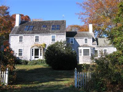 Undisclosed Address Falmouth, MA 02540 - Photo 2 of 14 a front view of a house with a garden