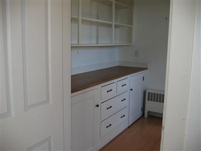 Undisclosed Address Falmouth, MA 02540 - Photo 5 of 14 a kitchen with white cabinets and a stove