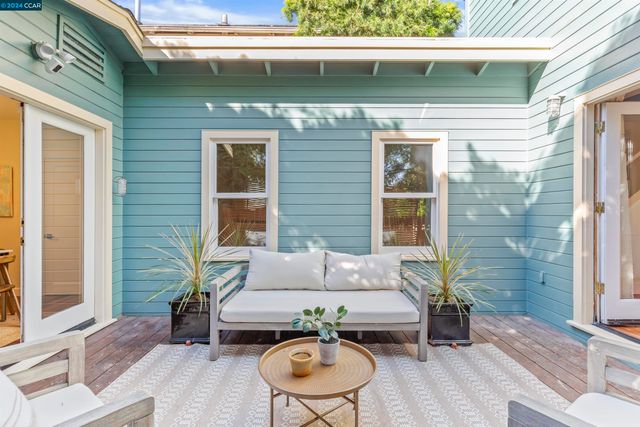 a backyard of a house with table and chairs