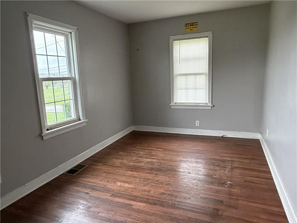 1146 Franklin Road Jackson Center, PA 16133 - Photo 14 of 19 an empty room with wooden floor and windows