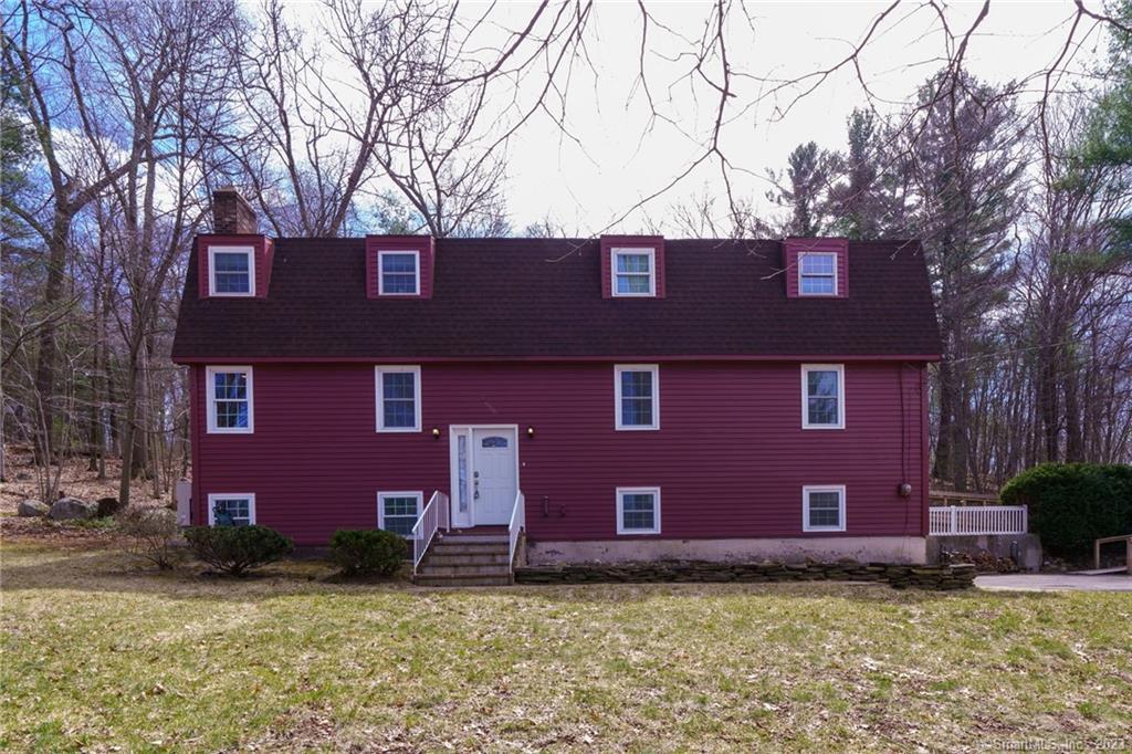 a house that has a tree in front of a house