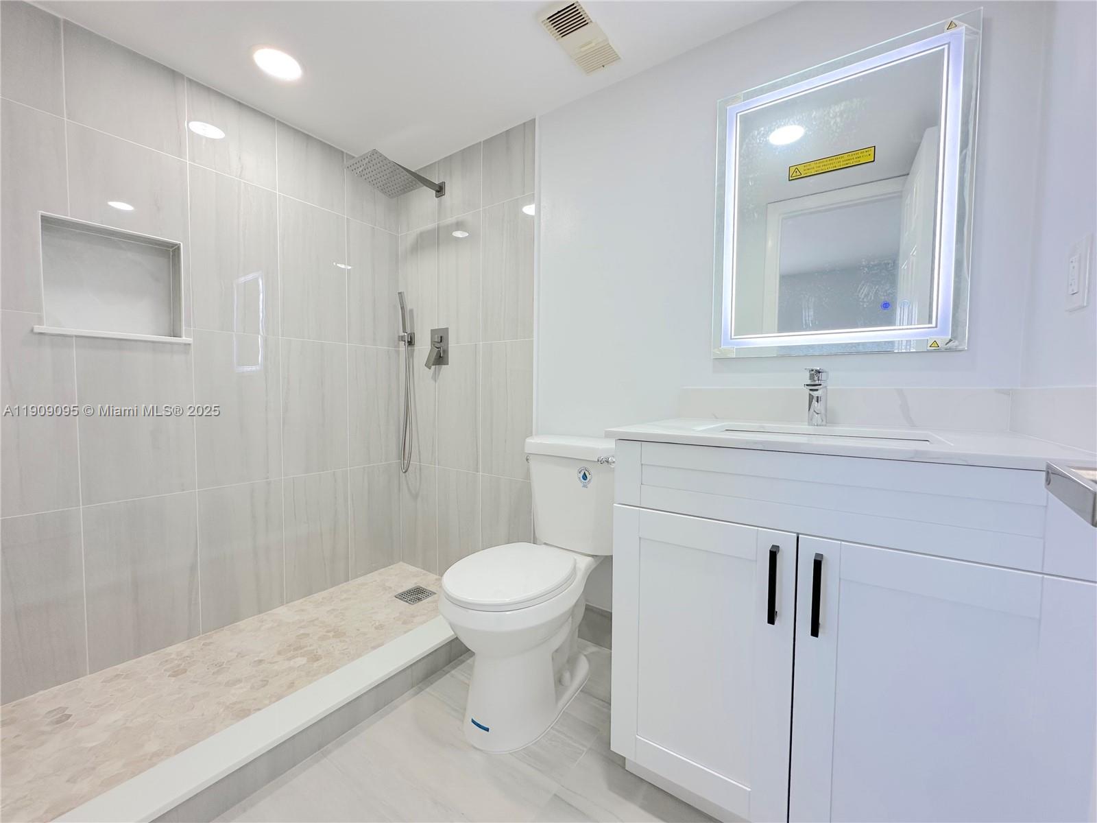 3110 North Pine Island Road, Unit 408 Sunrise, FL 33351 - Photo 13 of 18 a bathroom with a sink toilet and shower