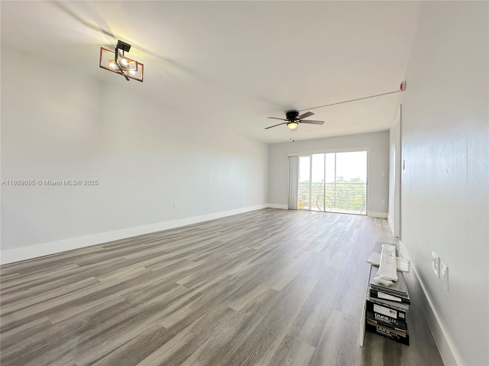 3110 North Pine Island Road, Unit 408 Sunrise, FL 33351 - Photo 5 of 18 an empty room with wooden floor and windows
