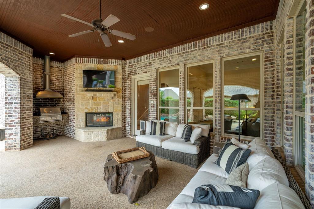2101 Vail Road Southlake, TX 76092 - Photo 34 of 40 a living room with furniture a fireplace and a flat screen tv
