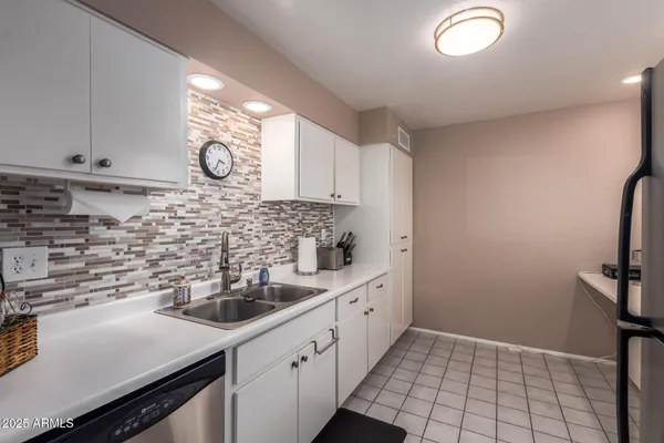 a kitchen with a sink and cabinets