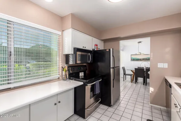 a kitchen with stainless steel appliances a refrigerator and a sink