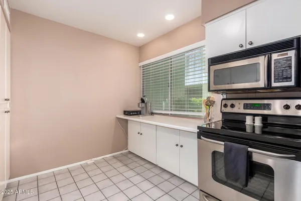 a kitchen with appliances a sink and cabinets