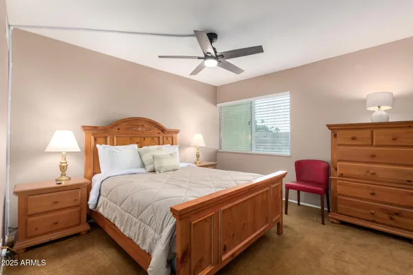 a bedroom with a bed and a dresser