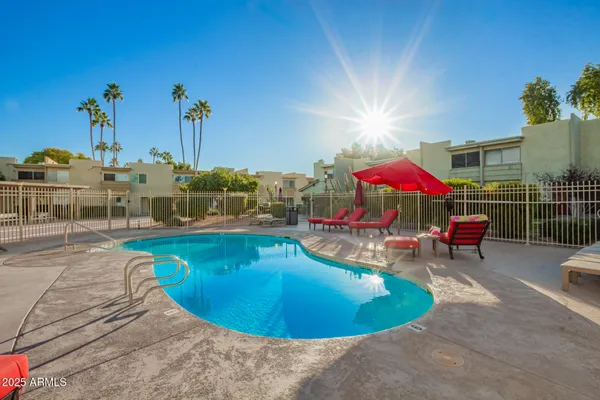 a view of a swimming pool with a lounge chairs