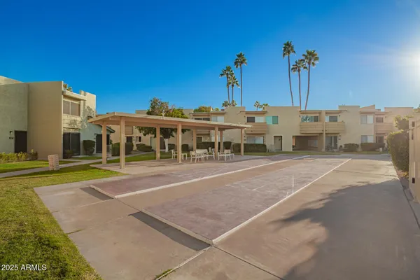 a view of a patio with a table and chairs