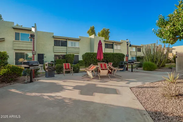 a building outdoor space with patio furniture and potted plants