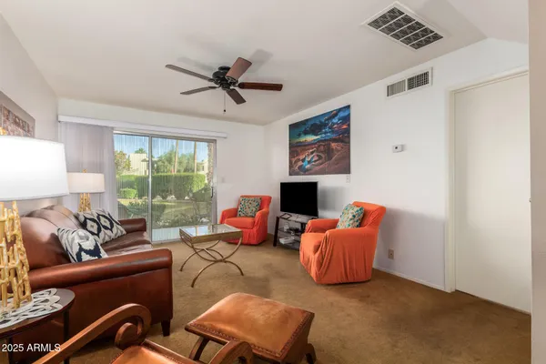 a living room with furniture and a large window