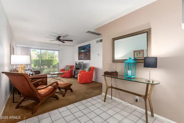 a living room with furniture a window and a flat screen tv