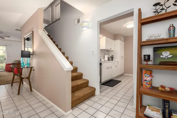 a view of hallway with furniture and a fireplace