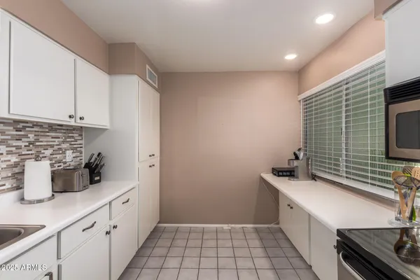 a kitchen with a sink a stove and cabinets