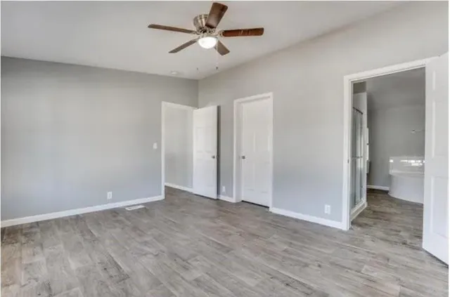 a bathroom with a granite countertop sink a toilet and bathtub