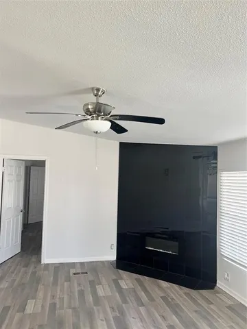 a kitchen with stainless steel appliances granite countertop a stove top oven a sink and white cabinets