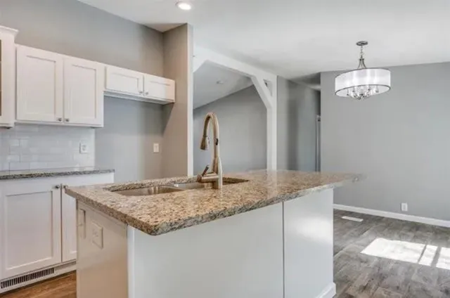 a kitchen with stainless steel appliances granite countertop a stove and a microwave