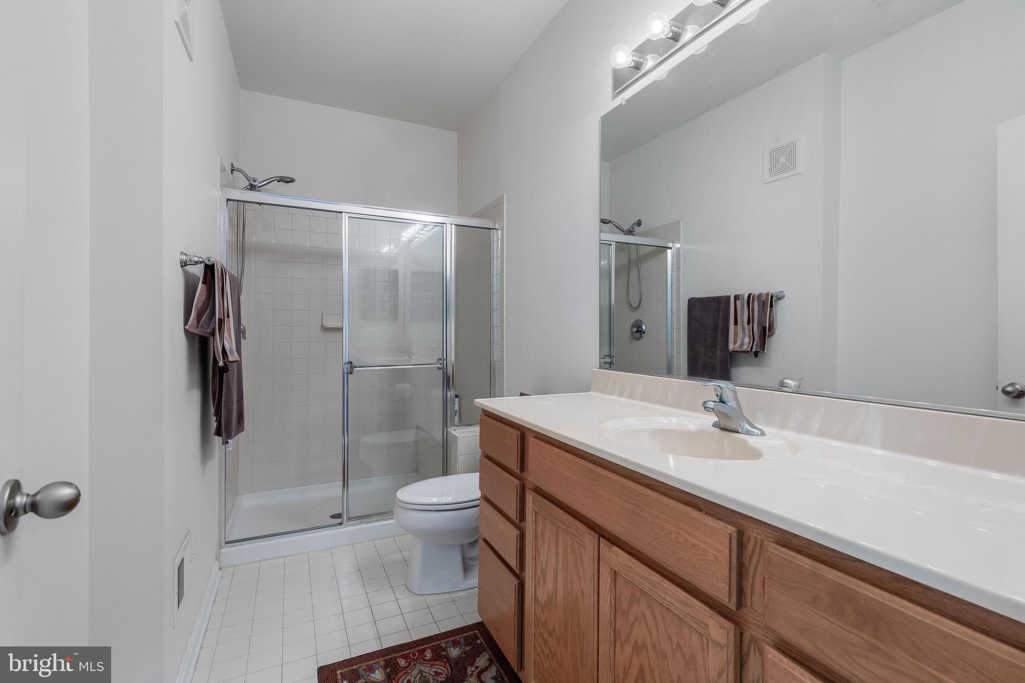 9409 Stonewall Road Manassas, VA 20110 - Photo 12 of 26 a bathroom with a sink toilet and shower