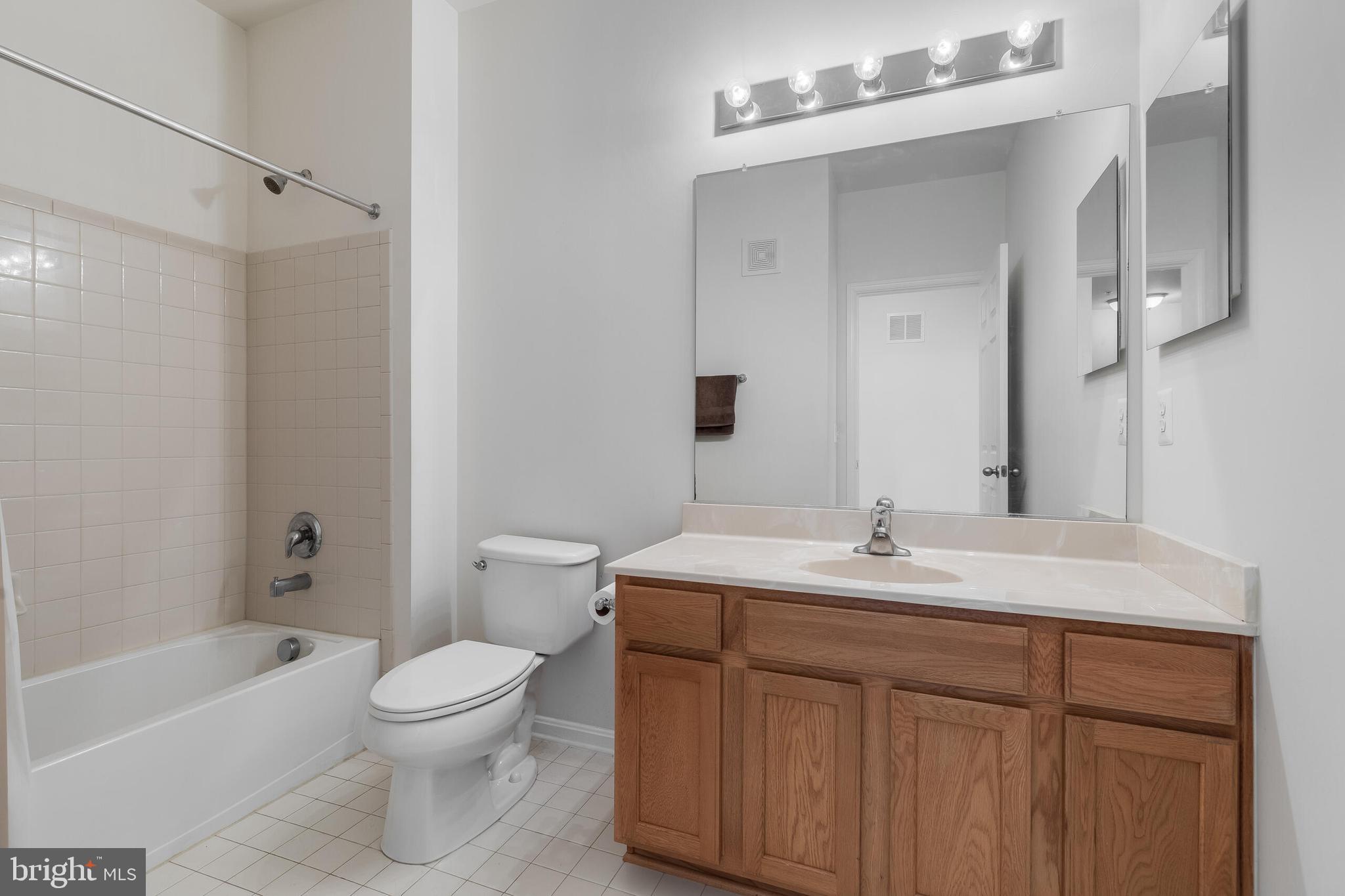 9409 Stonewall Road Manassas, VA 20110 - Photo 19 of 26 a bathroom with a sink a toilet and shower