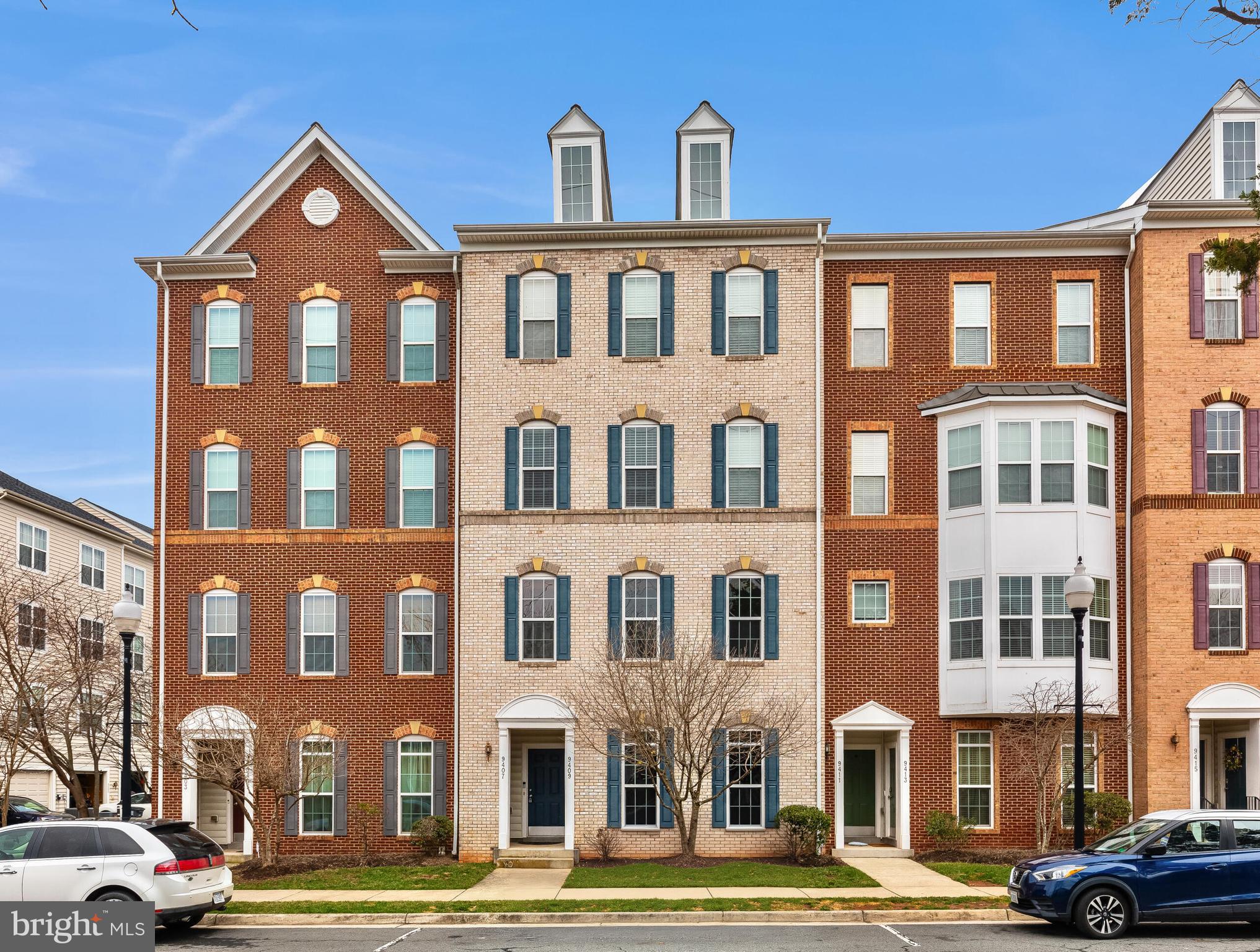 9409 Stonewall Road Manassas, VA 20110 - Photo 2 of 26 a front view of a residential apartment building with a yard