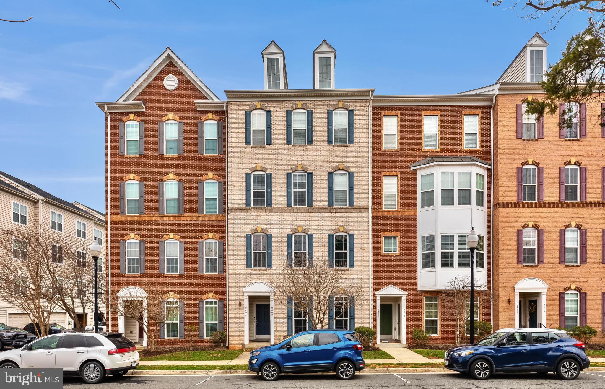 9409 Stonewall Road Manassas, VA 20110 - Photo 24 of 26 a front view of a building with lot of cars and trees