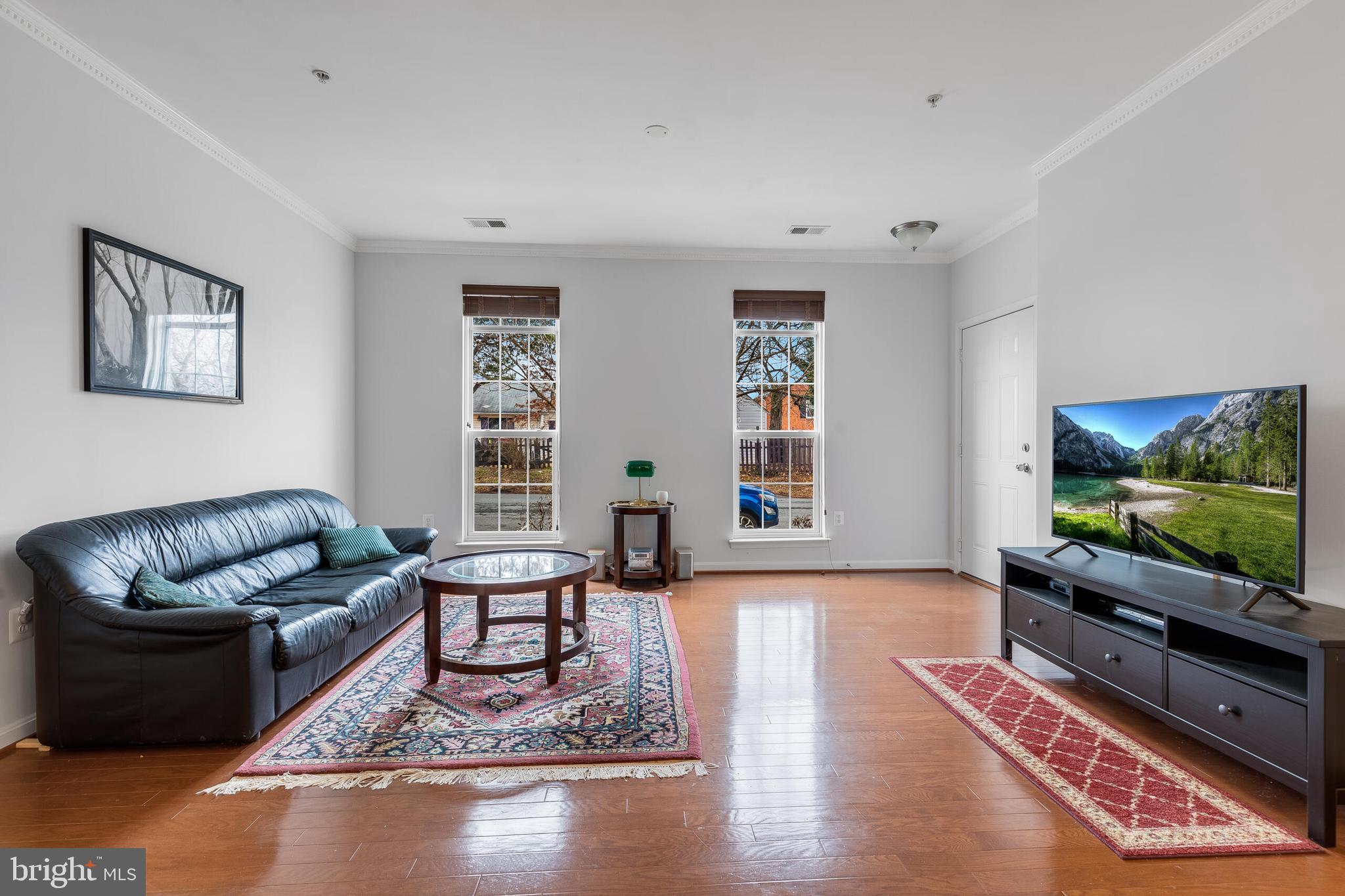 9409 Stonewall Road Manassas, VA 20110 - Photo 4 of 26 a living room with furniture and a flat screen tv