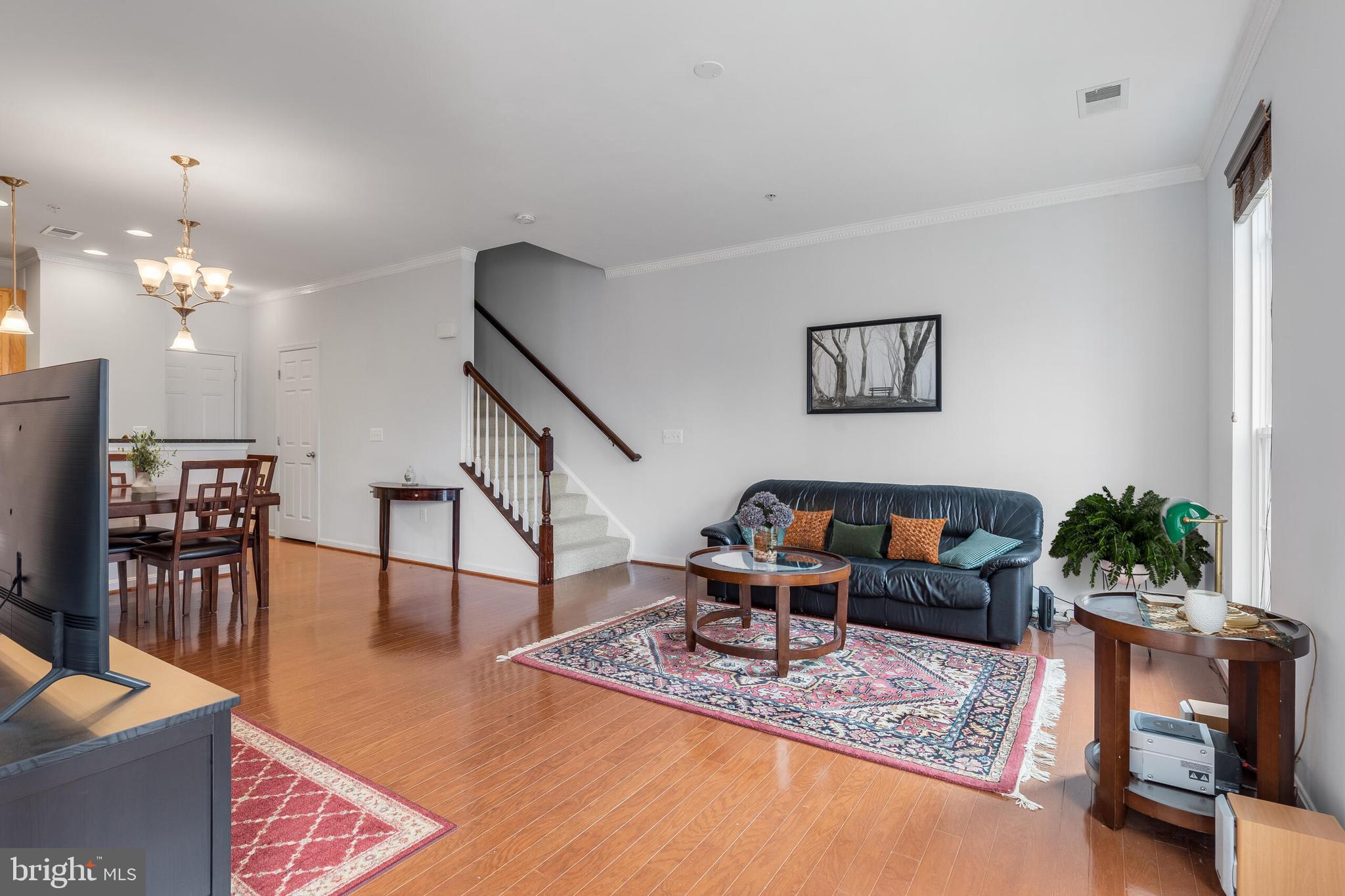 9409 Stonewall Road Manassas, VA 20110 - Photo 5 of 26 a living room with furniture a dining table and a potted plant
