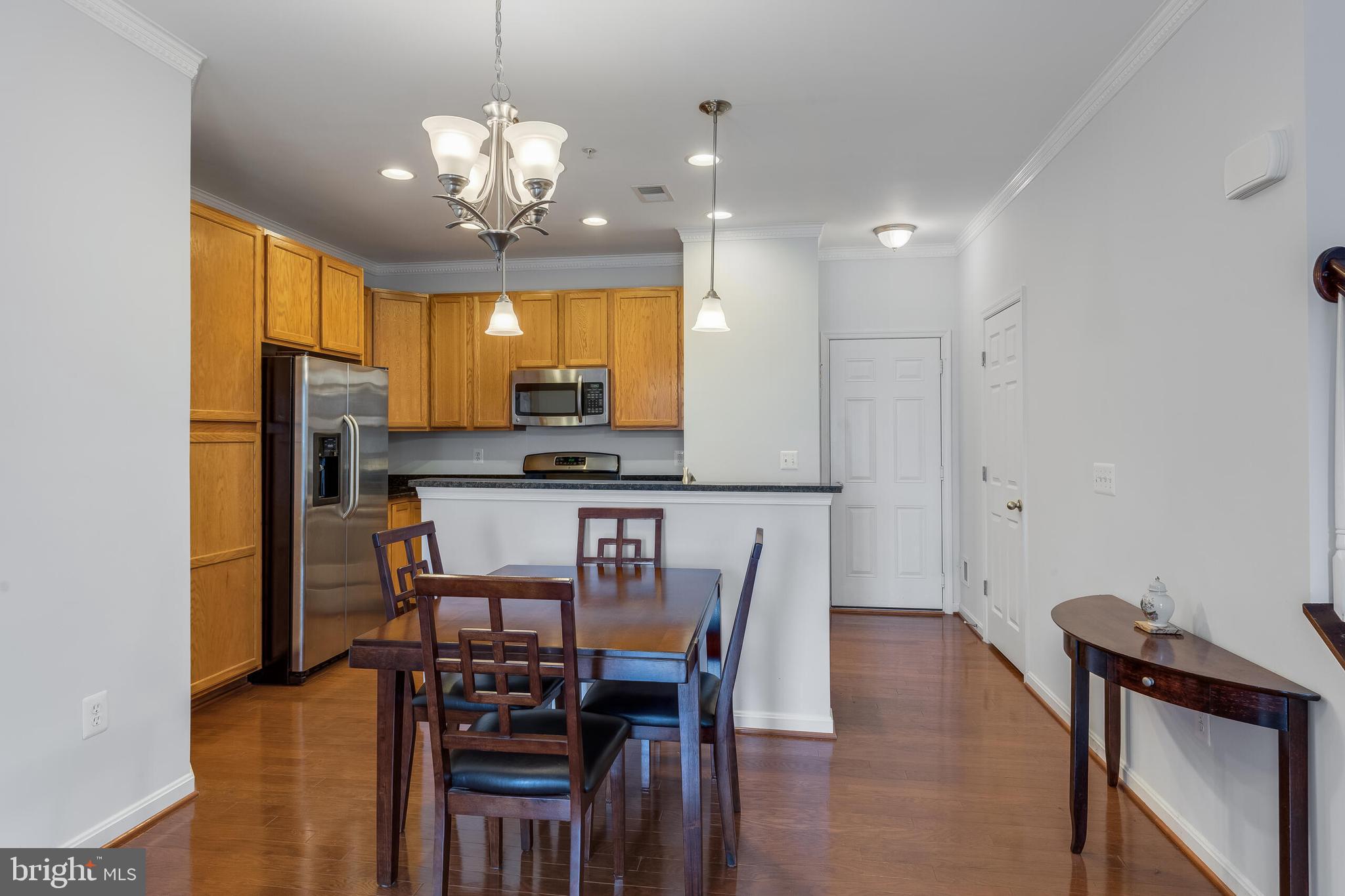 9409 Stonewall Road Manassas, VA 20110 - Photo 6 of 26 a view of a dining room with furniture and wooden floor