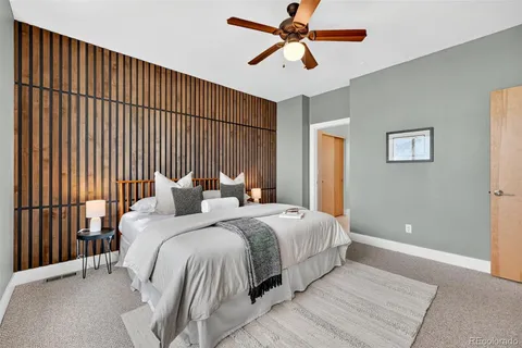 a view of roof deck with couches and potted plants