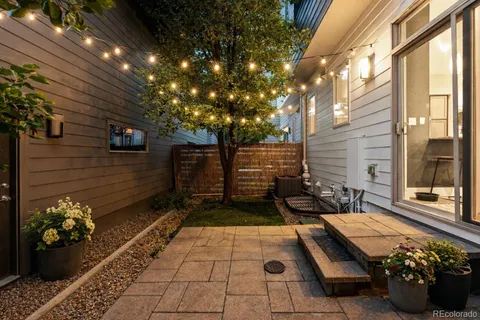 a view of a backyard with chairs and a fire pit
