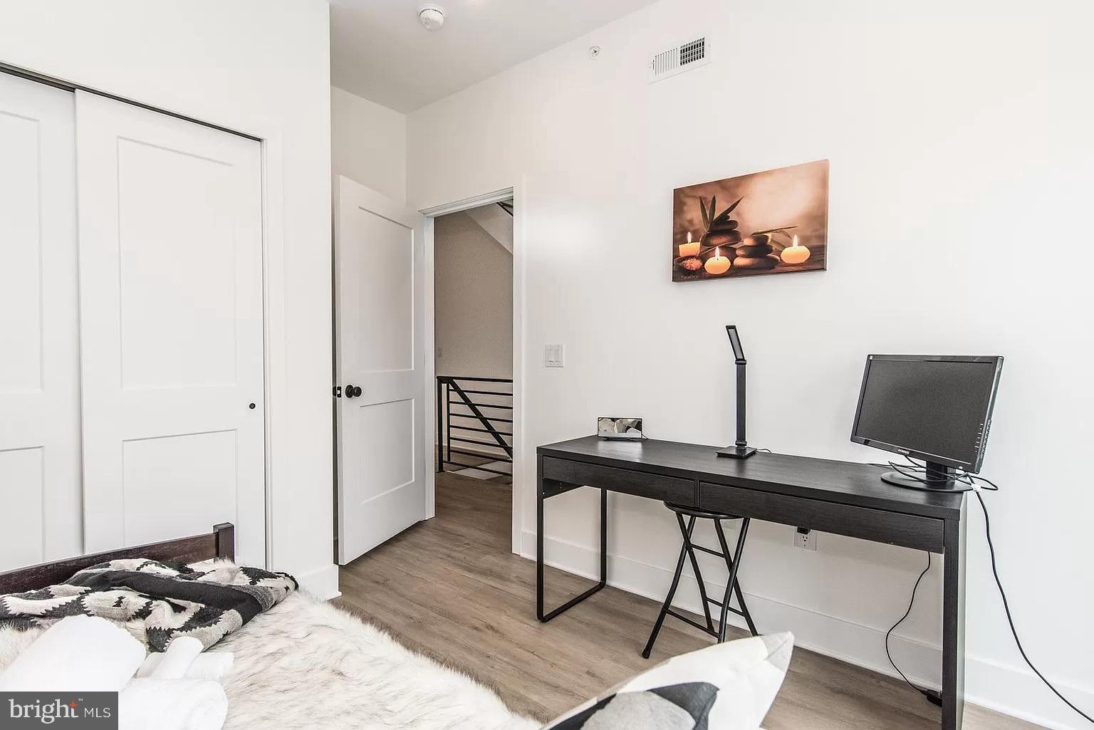 2435 Master Street, Unit 2 Philadelphia, PA 19121 - Photo 5 of 9 a view of a workspace with furniture and wooden floor
