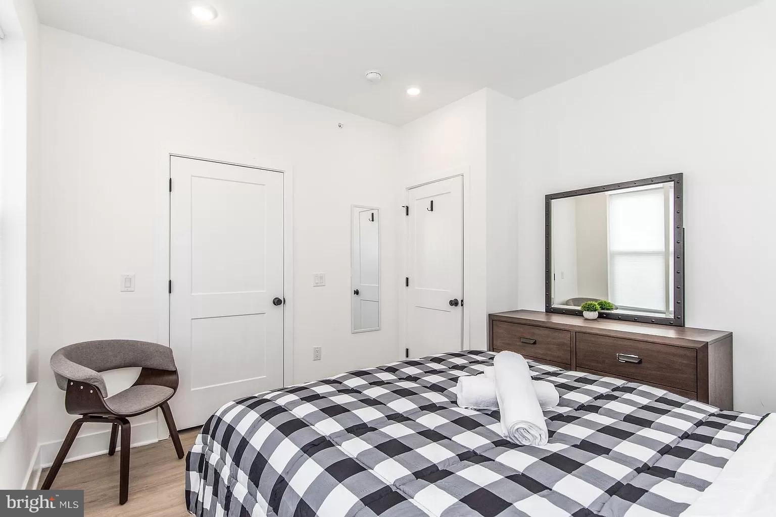 2435 Master Street, Unit 2 Philadelphia, PA 19121 - Photo 6 of 9 a bedroom with a bed and a chair