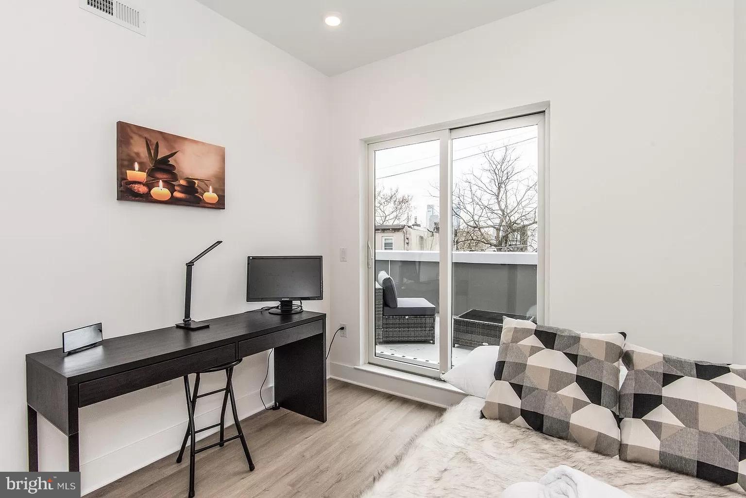 2435 Master Street, Unit 2 Philadelphia, PA 19121 - Photo 7 of 9 a view of a workspace with furniture and a window