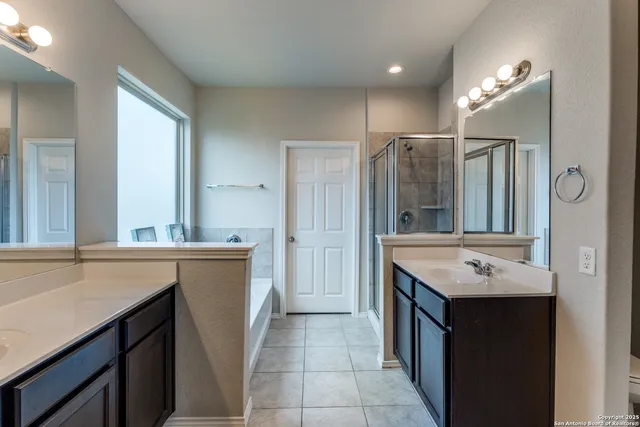 a bathroom with a sink double vanity and a mirror