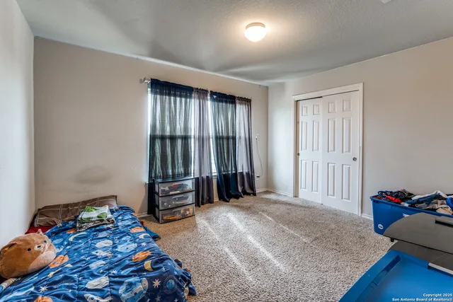 a bedroom with a bed and a closet