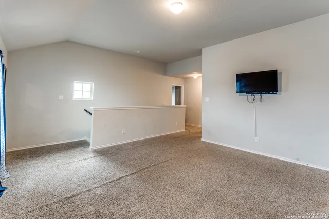a view of a livingroom with an empty space and a window