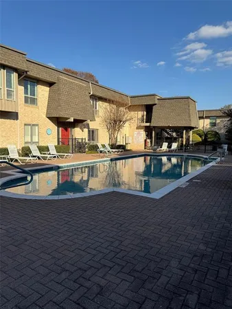 a view of a swimming pool with a patio