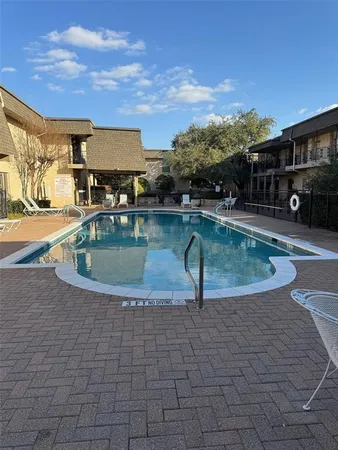 a view of swimming pool with outdoor seating
