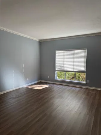 a view of hallway with bathroom and wooden floor