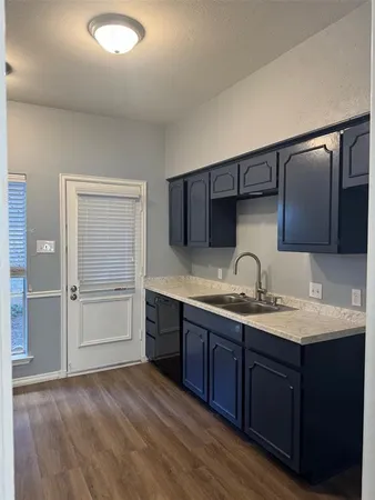 a kitchen with stainless steel appliances wooden cabinets and a stove top oven