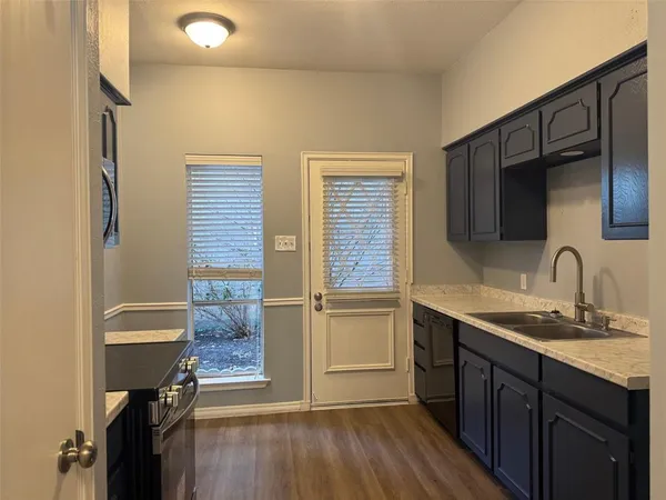 a kitchen with a sink appliances and cabinets