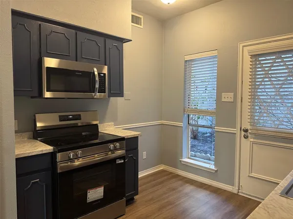 a kitchen with a stove and a microwave