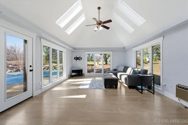 a living room with couches a coffee table and a dining table with wooden floor