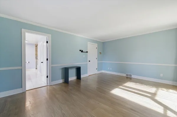 a bathroom with a granite countertop sink a mirror and shower