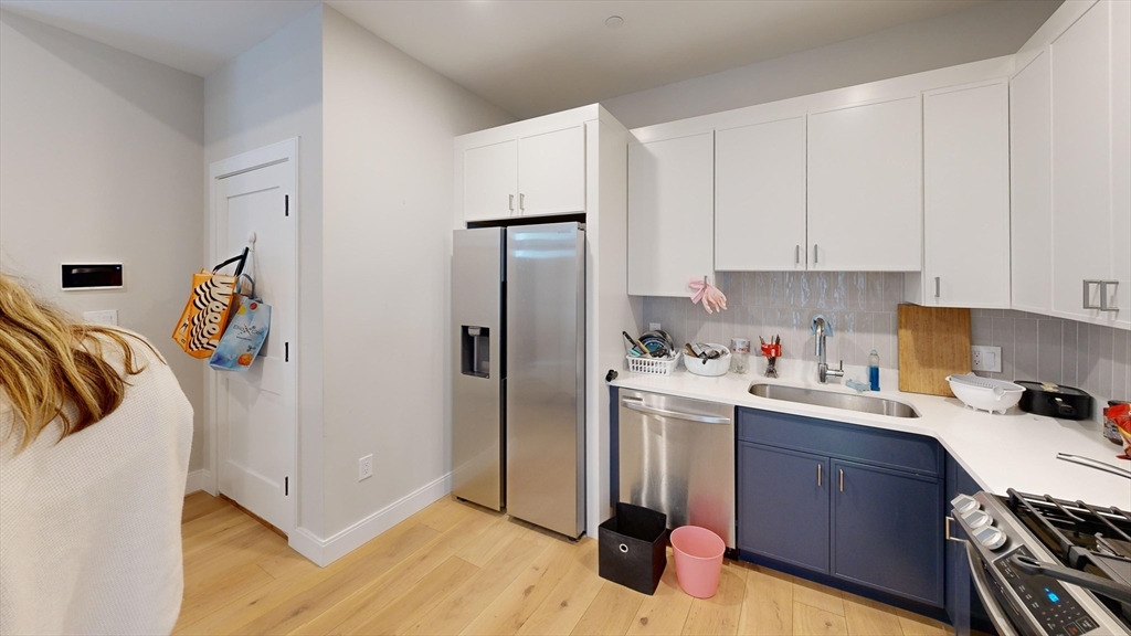 157 Everett Street, Unit 202 Boston, MA 02134 - Photo 2 of 7 a kitchen with a refrigerator sink and cabinets